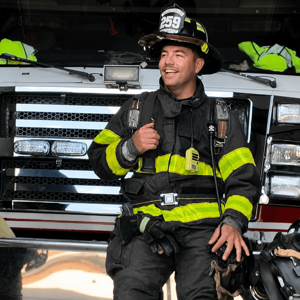 Daniel Quinn in turnout gear in front of a fire engine